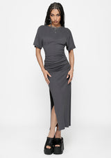 Woman wearing a grey midaxi dress with a thigh slit on a white background